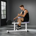 A young man using an adjustable seated calf raise machine in a gym setting, focused on his workout.