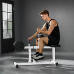 Seated adjustable seated calf raise machine being used by a young man in workout attire.