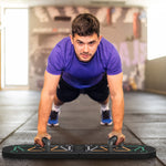 Man performing push-ups on a foldable push up board, targeting upper body muscles in a gym setting.